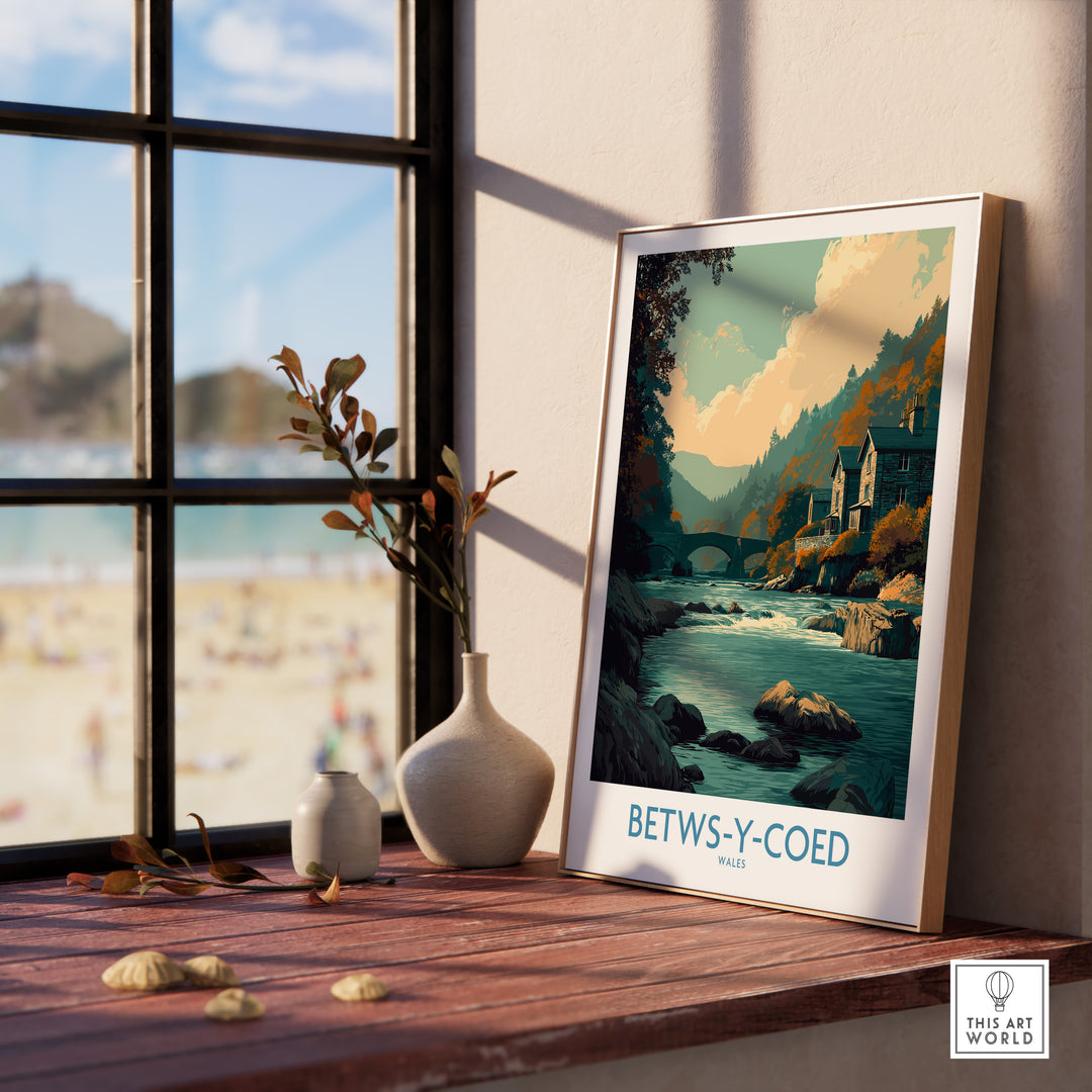Betws-y-Coed poster art print on a table, showcasing serene landscapes and Welsh charm in a cozy setting.