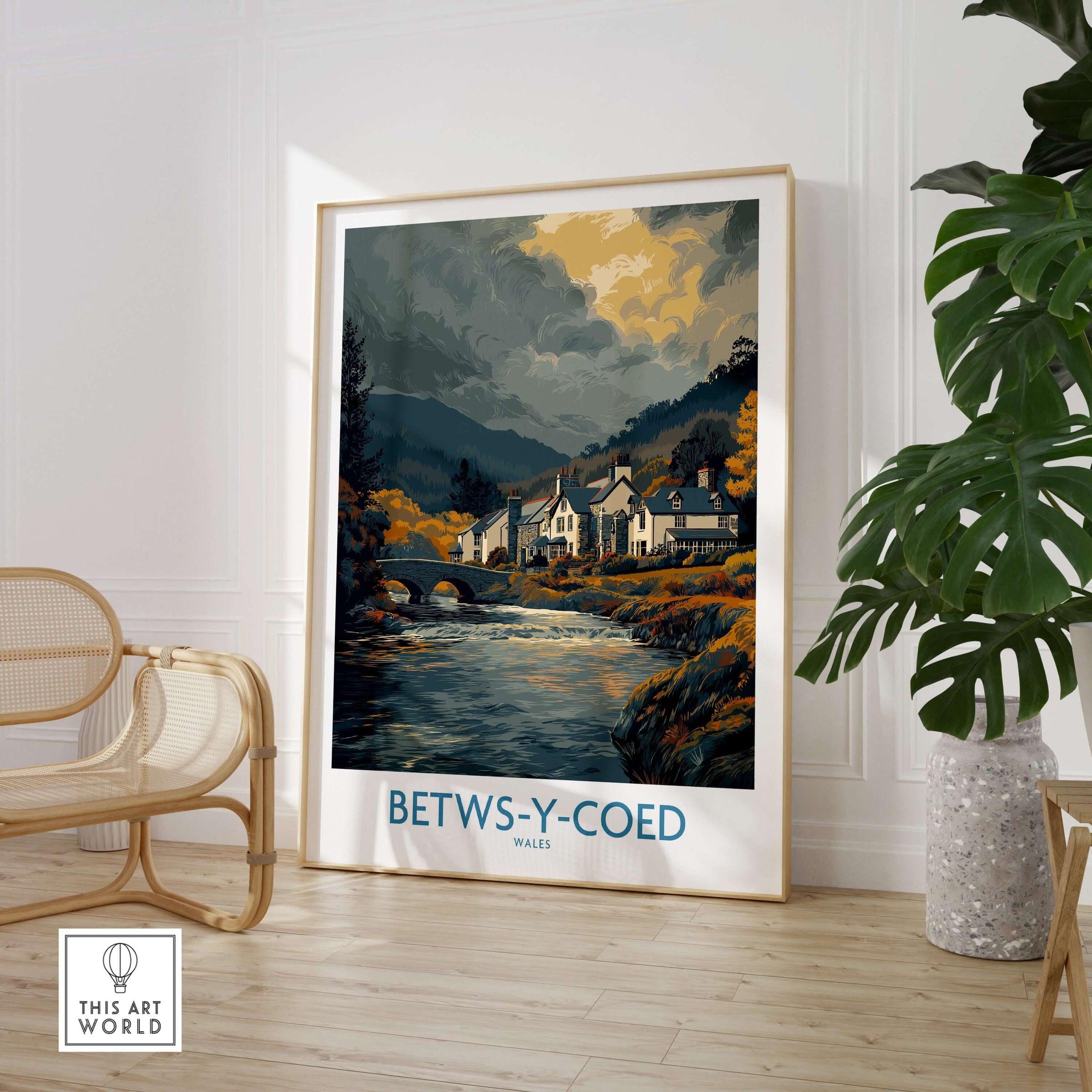 Betws-y-Coed Poster Wales Countryside Landscape Print displayed in a stylish home interior with green plants.