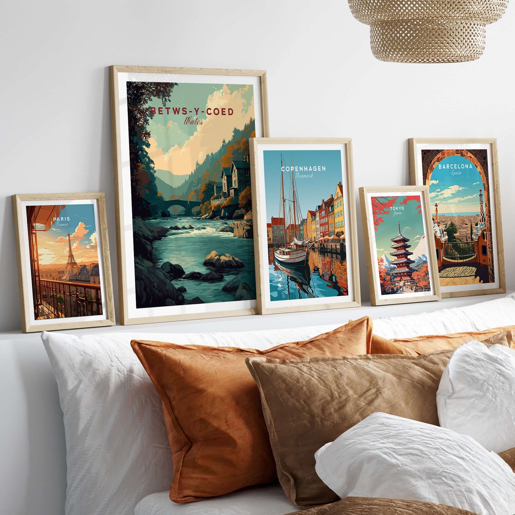 Framed artwork featuring Betws-y-Coed Travel Print Wales among other travel prints in a cozy interior setting.