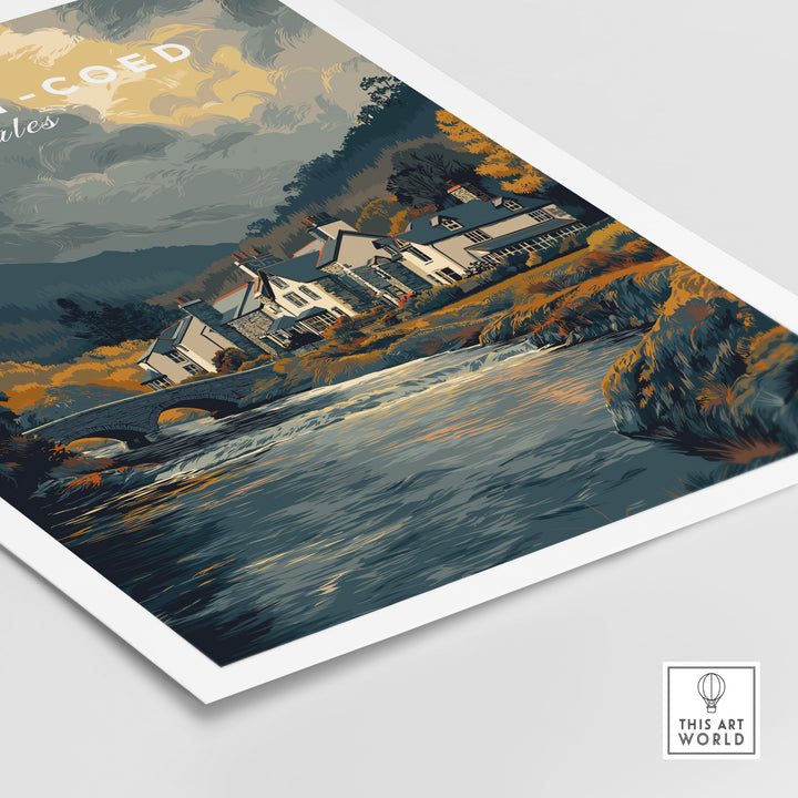 Betws-y-Coed travel poster art featuring quaint homes by a river in Snowdonia, Wales.