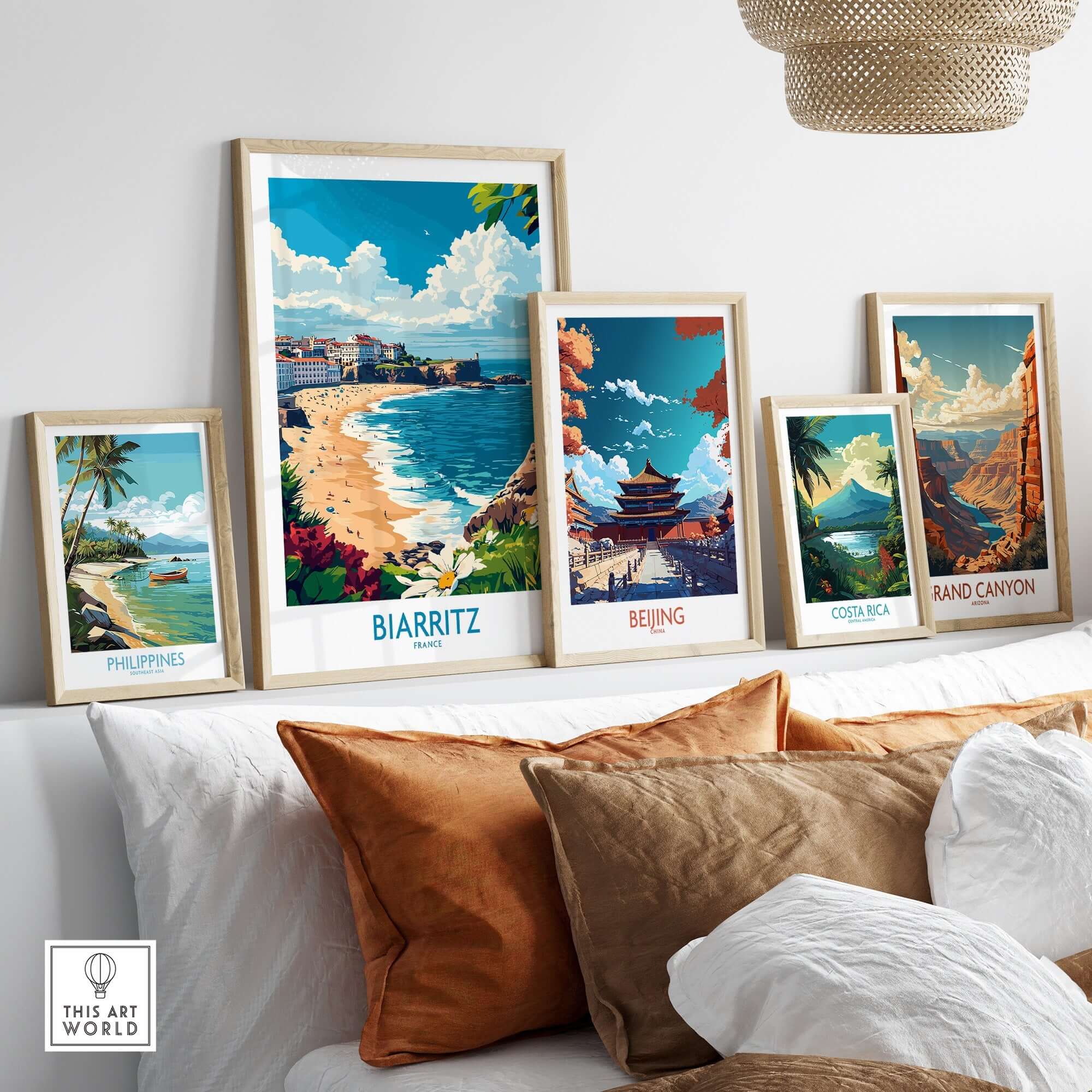 Biarritz Poster France displayed among other travel-themed art prints on a stylish sofa.