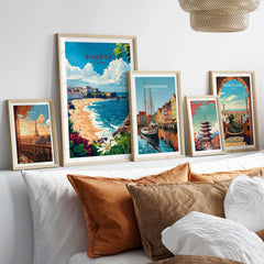 Biarritz Print poster surrounded by travel posters from Copenhagen and Barcelona on a stylish living room wall.