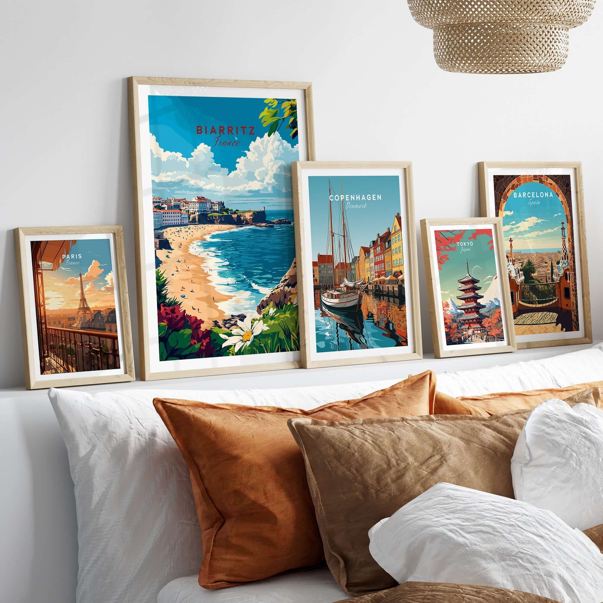Biarritz Print poster surrounded by travel posters from Copenhagen and Barcelona on a stylish living room wall.