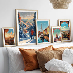 Big Bear travel poster displayed among other vibrant city posters on a stylish shelf above a cozy bed.