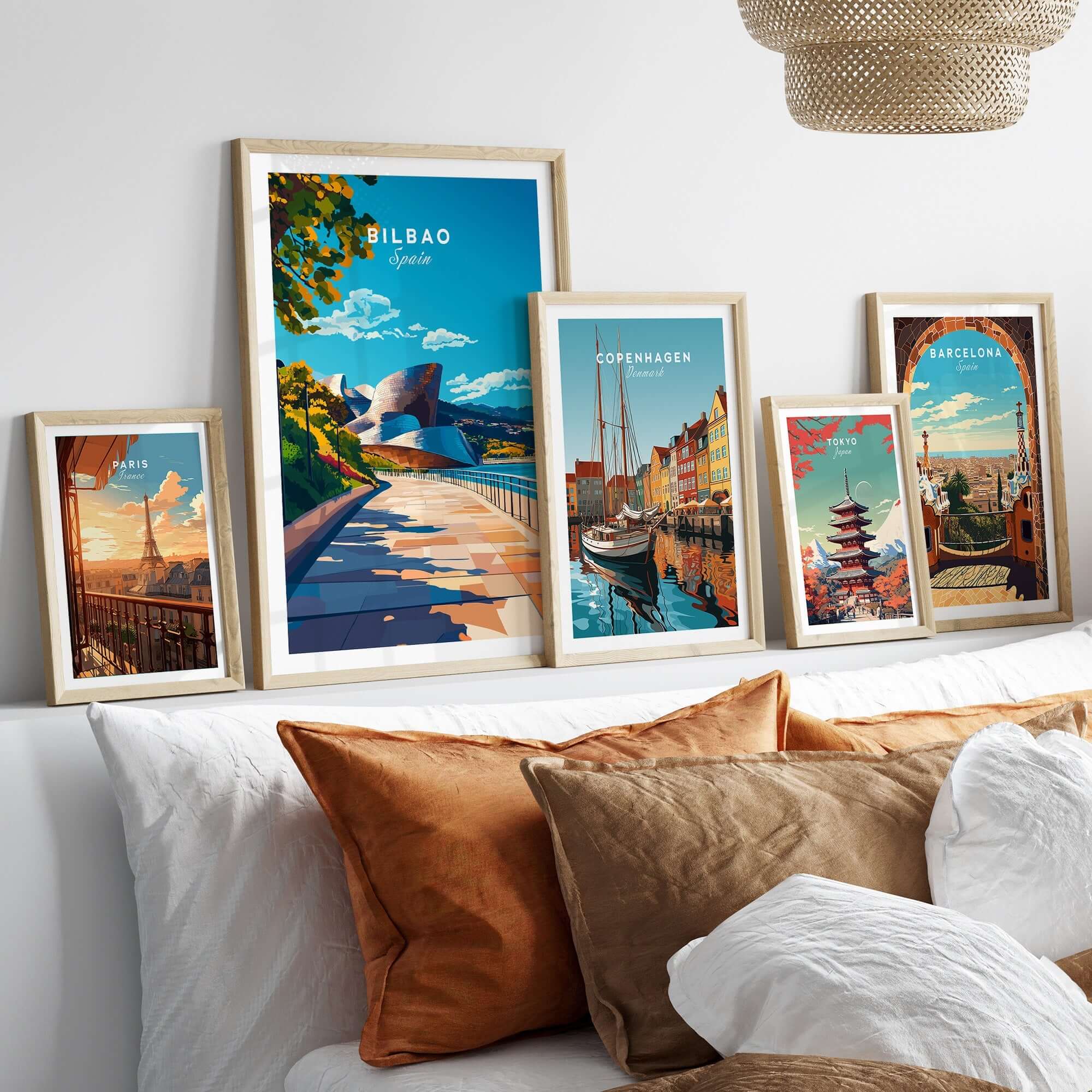 A collection of vibrant framed posters, including the Bilbao Print, showcasing colorful cityscapes and creative designs.