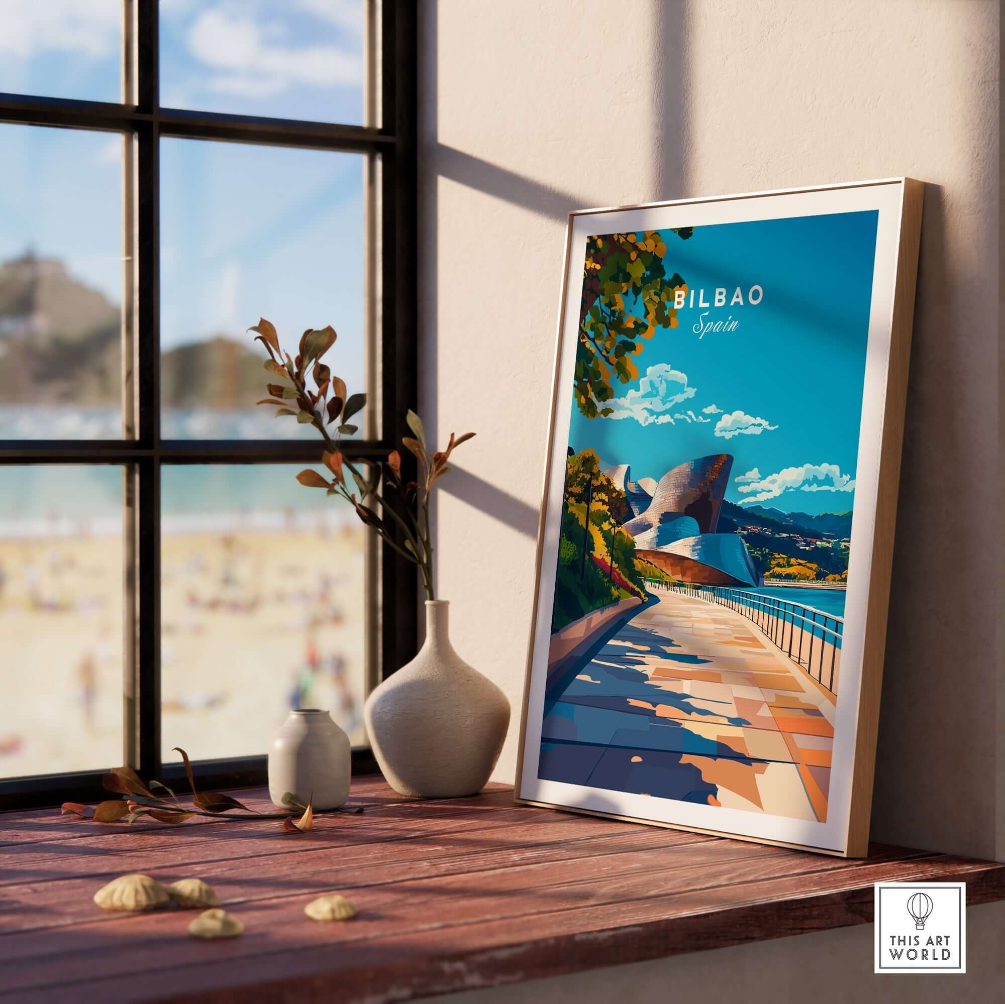 Bilbao Print poster displayed on a table with a view of the beach, adding vibrant decor to the room.