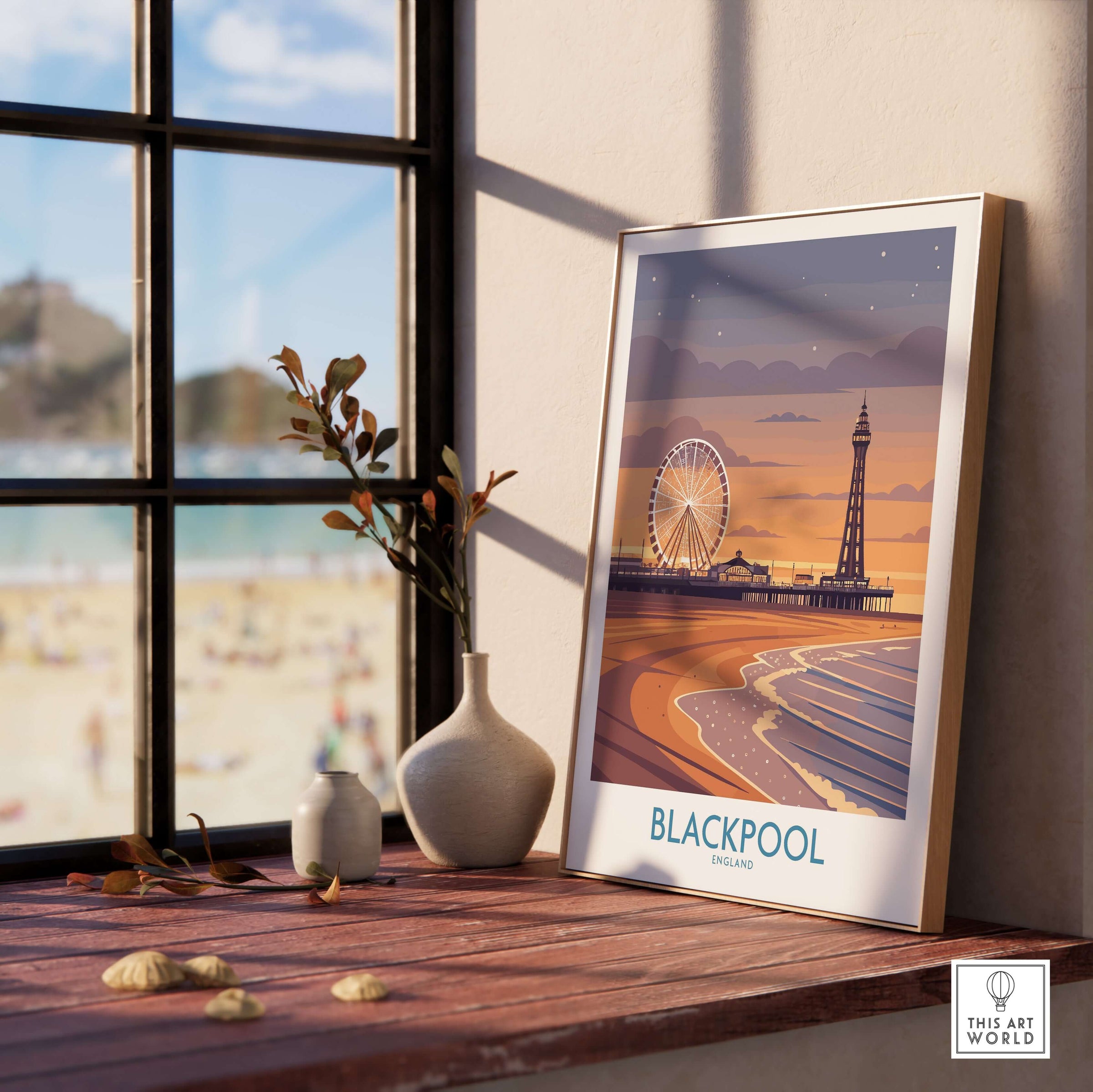 Blackpool England Tower and Wheel Art Print | Sunset Beach Resort Poster displayed on a wooden table by a window.