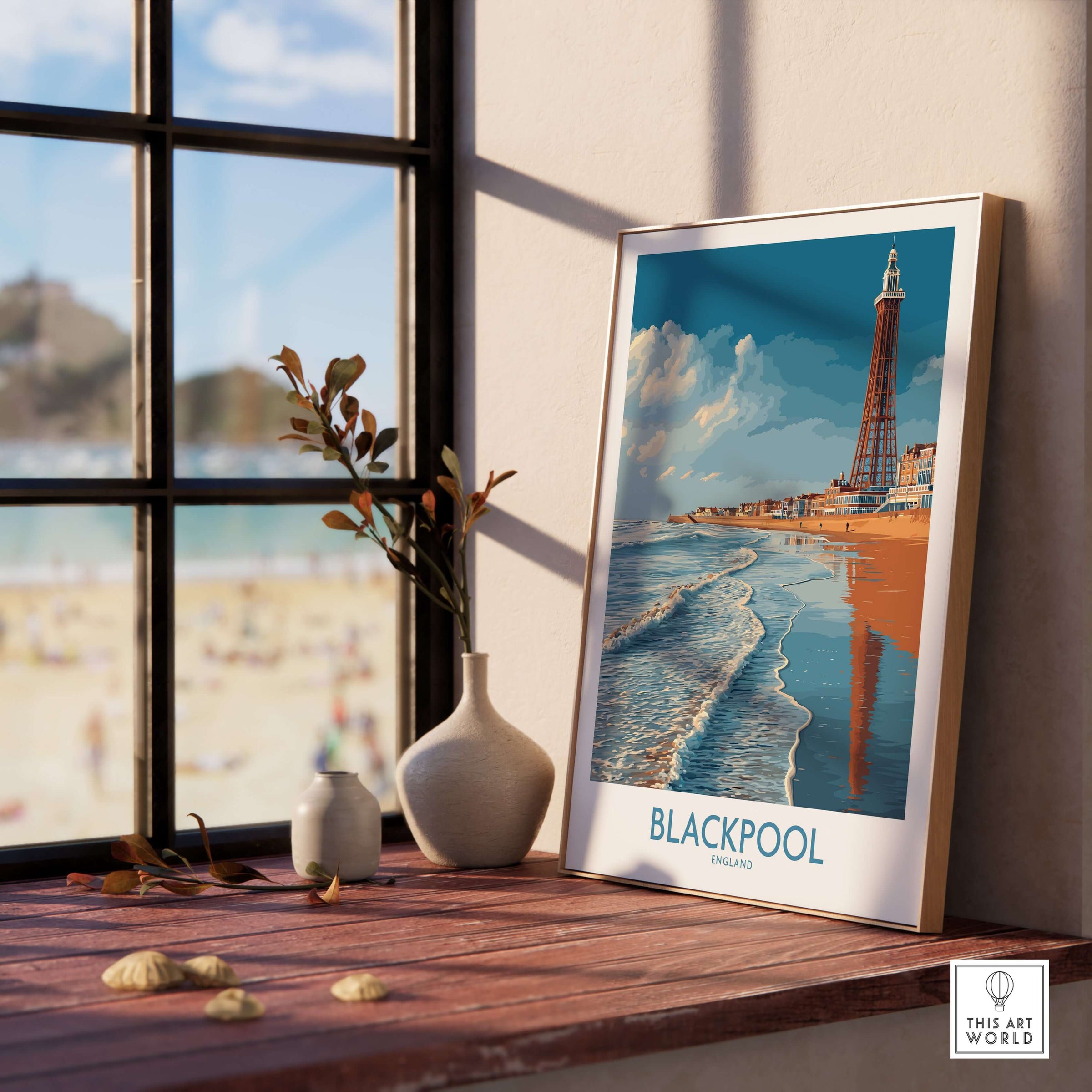 Blackpool England Tower Seascape Art Print | Beach Travel Poster displayed on a wooden table near a window.