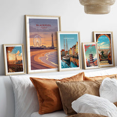 Blackpool Print | UK Coastal Wall Decor displayed among decorative framed prints on a stylish bed backdrop.