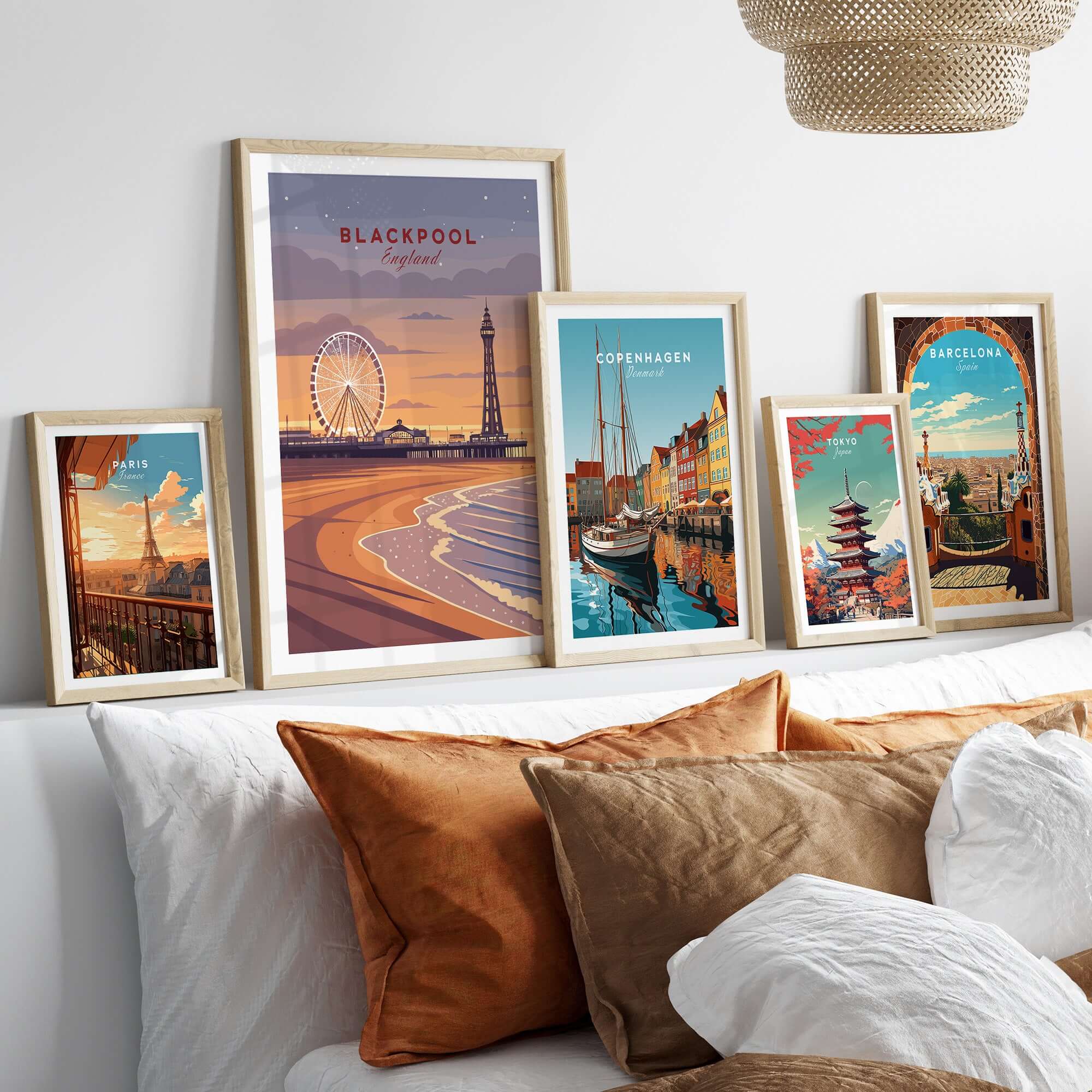 Blackpool Print | UK Coastal Wall Decor displayed among decorative framed prints on a stylish bed backdrop.