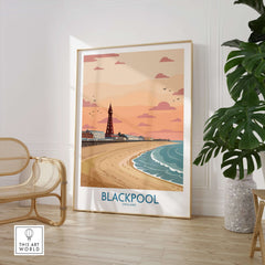 Blackpool Sunset Tower Beach Art Print | Pink Sky UK Coastal Poster displayed in a cozy interior with plants.
