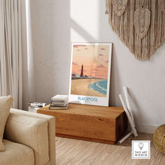 Blackpool Sunset Tower Beach Art Print | Pink Sky UK Coastal Poster displayed in living room decor.