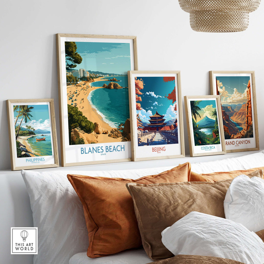 Art display featuring Blanes Beach Spain travel poster among other travel wall art, perfect for beach lovers and decor.
