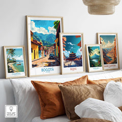 Bogota Art Print showcased among other framed travel posters on a stylish couch.