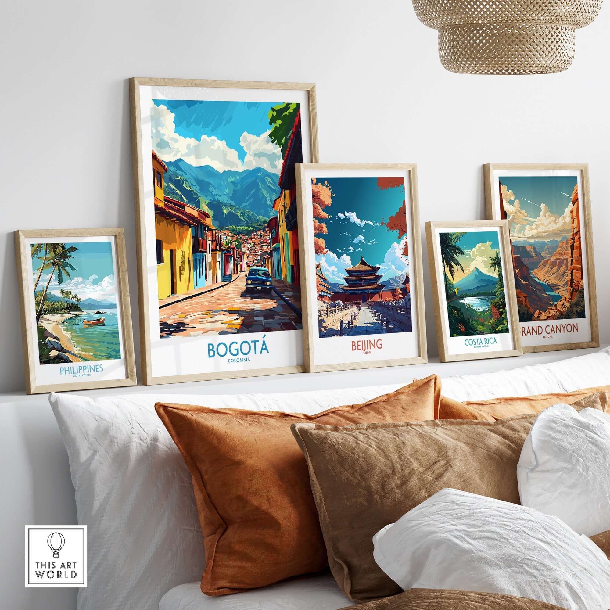 Bogota Art Print showcased among other framed travel posters on a stylish couch.