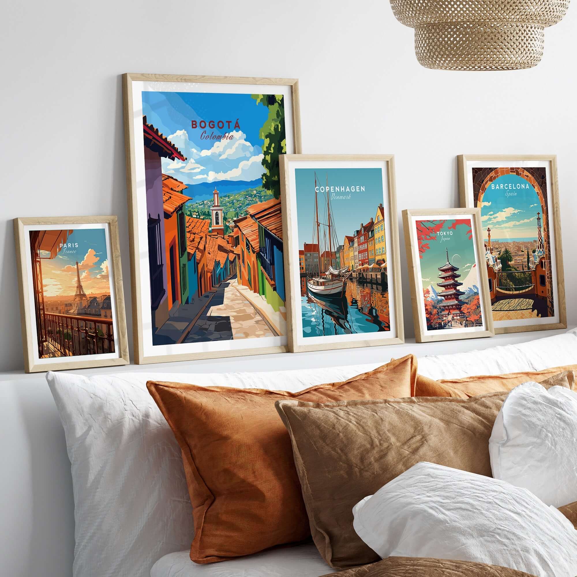 Bogota Travel Print displayed among framed travel posters on a stylish sofa with decorative pillows.