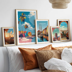 Bonaire Caribbean Colorful Houses Print - Tropical Beach Art Poster displayed among other travel art posters on a cozy bed.