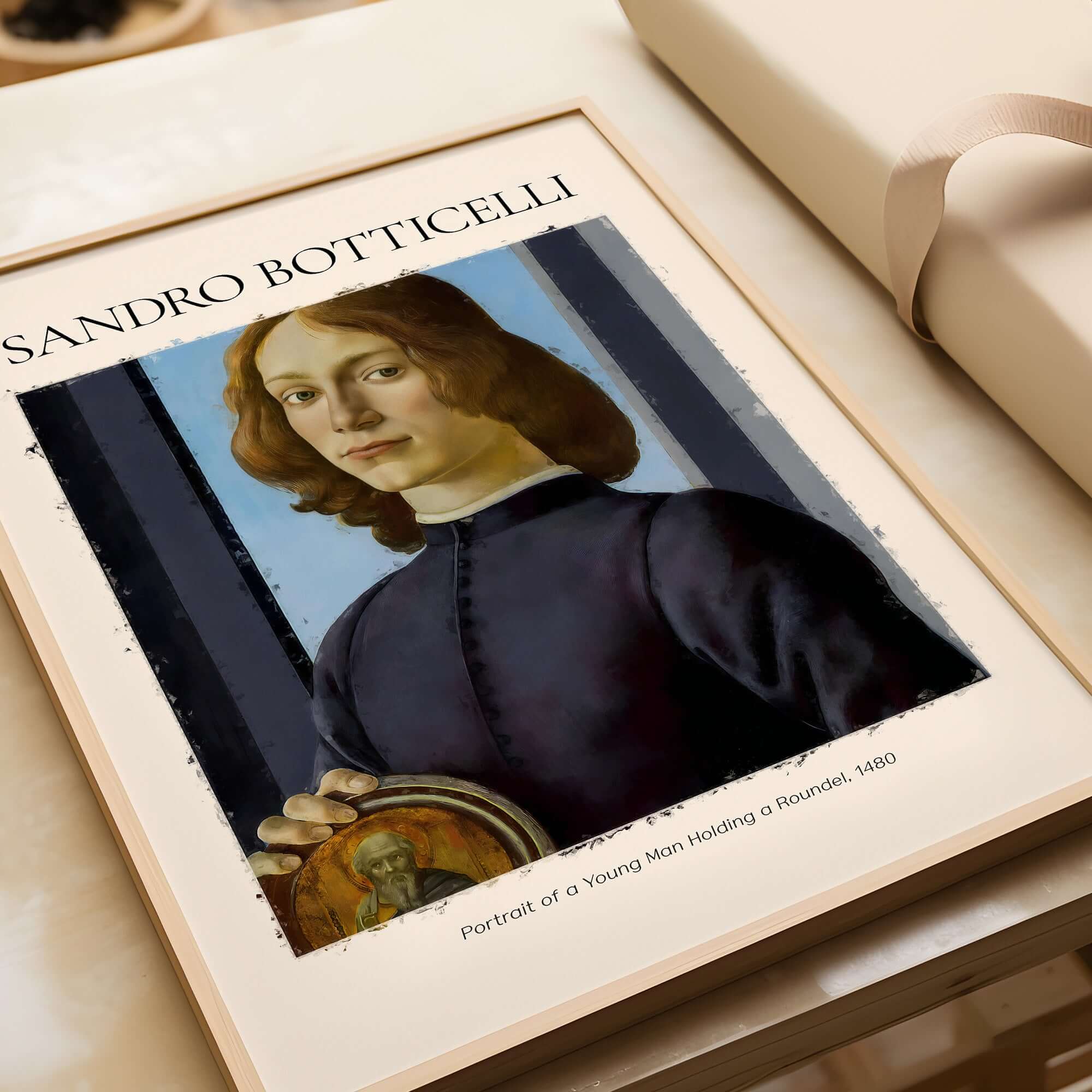 Botticelli Portrait of a Young Man Roundel 1480 Art Print Renaissance Florentine Poster framed on a table.