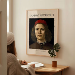 Botticelli Portrait Young Man Red Hat 1483 Art Print Renaissance Florentine Poster displayed in a modern setting.