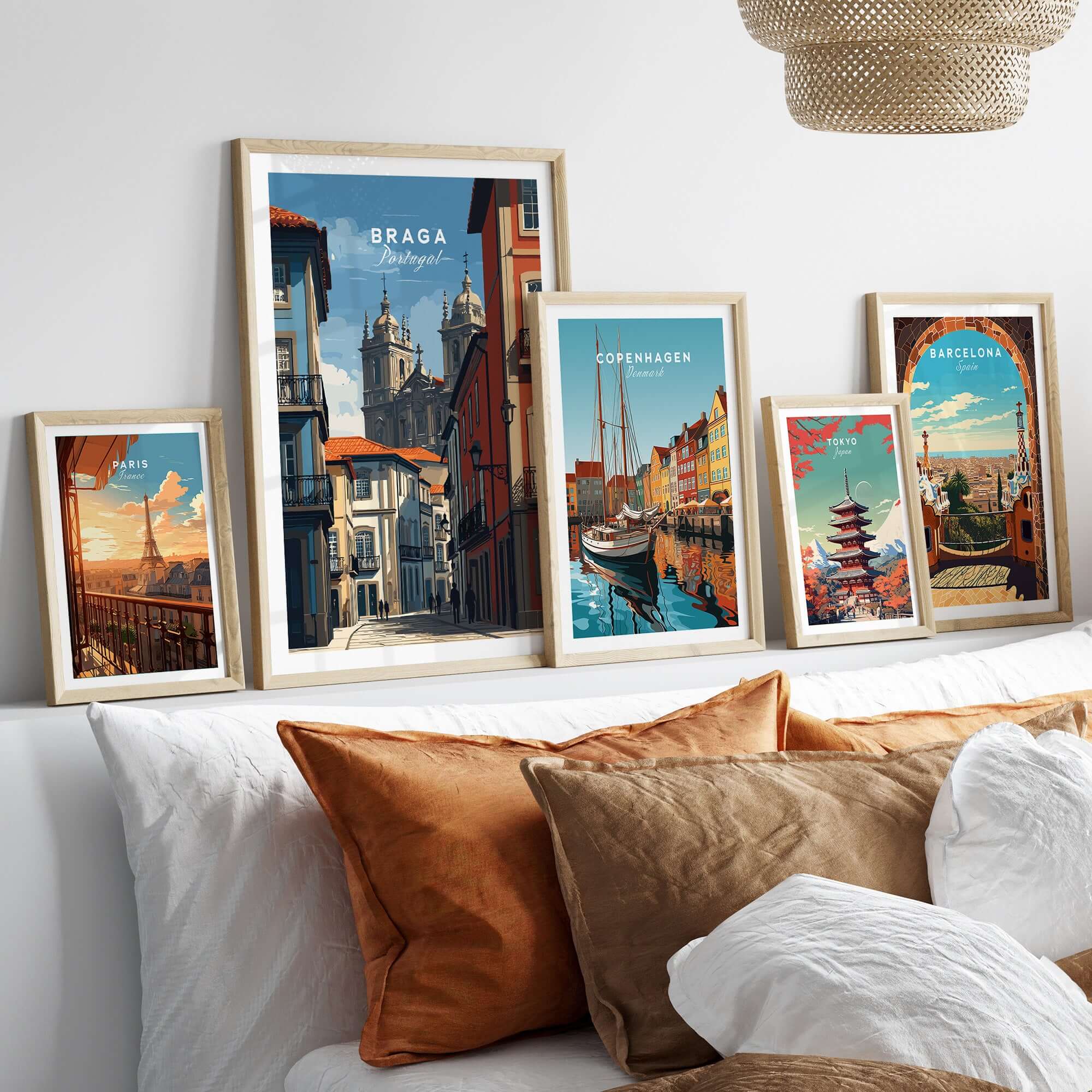 Braga Historic Centre Print | Portuguese Urban Wall Art displayed among other travel prints on a cozy bed with decorative pillows.