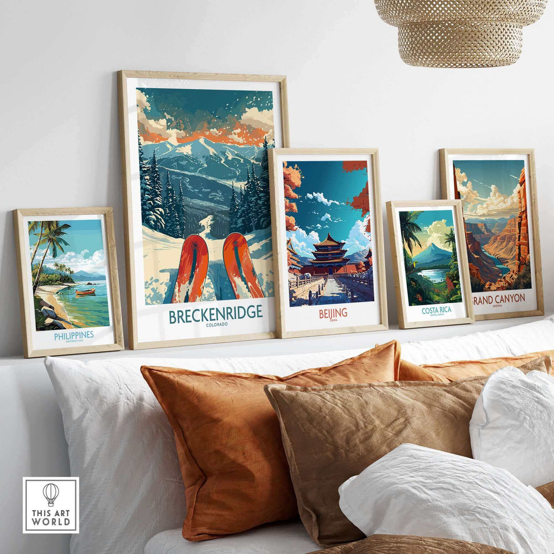 Collection of travel posters including Breckenridge Ski Poster, Beijing, Costa Rica, Grand Canyon, and Philippines displayed on a couch.