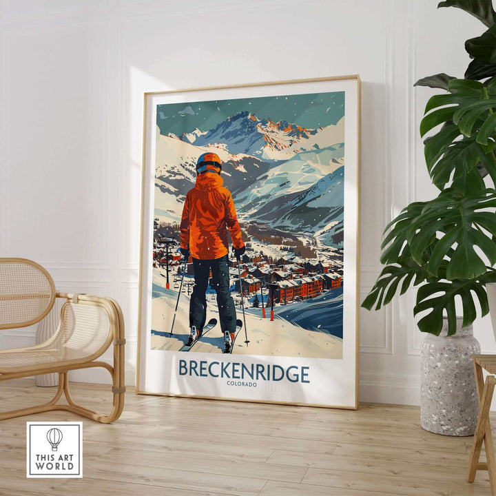 Breckenridge wall art featuring a skier in an orange jacket overlooking the snowy mountains and town of Breckenridge, Colorado.