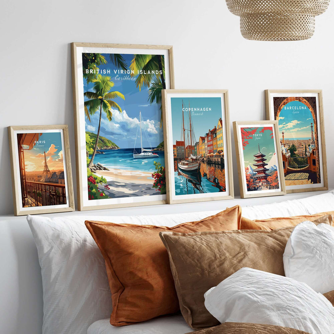 Framed travel prints of British Virgin Islands, Copenhagen, and Barcelona displayed on a stylish bed with decorative pillows.