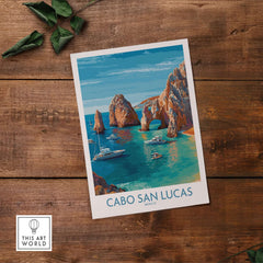 Cabo San Lucas Mexico Travel Poster El Arco Boats Turquoise Water Print Wall Art on a wooden table.