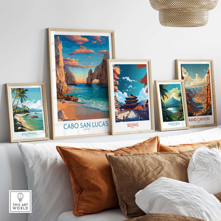 Collection of vibrant travel posters including Cabo San Lucas, Philippines, Beijing, Costa Rica, and Grand Canyon on a wall.