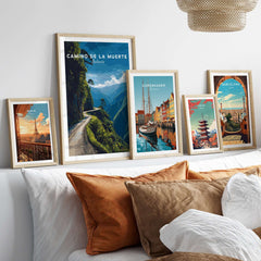 Camino de la Muerte Poster Bolivia Wall Art displayed among other travel posters on a cozy bed.