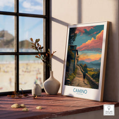 Camino de Santiago Pilgrim's Trail Art Print | Spiritual Travel Poster displayed on a wooden table near a window.