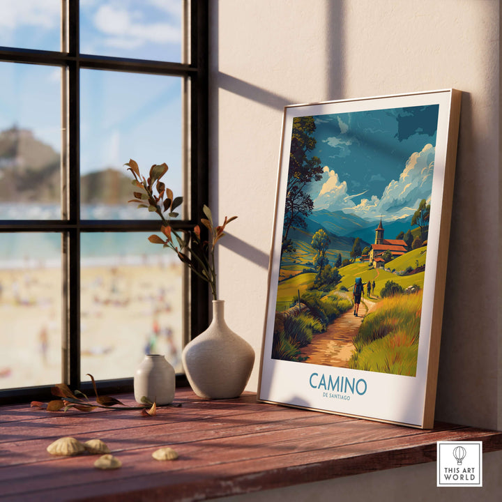 Camino de Santiago Rolling Hills Church Art Print | Green Landscape Poster displayed near a window with a beach view.