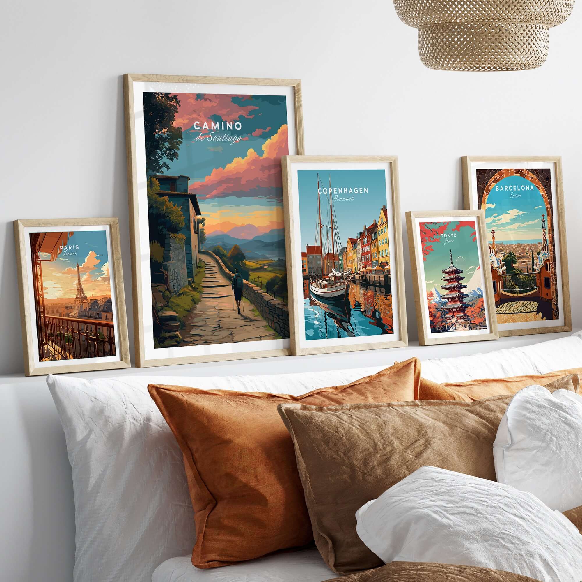 Camino de Santiago Sunset Path Print | Hiking Wall Decor Gift displayed among various travel prints on a stylish bed.