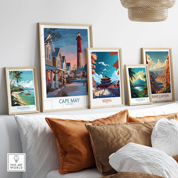 Five vibrant travel posters including Cape May Christmas Lights displayed on a cozy sofa.