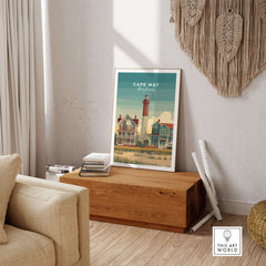 Cape May New Jersey Lighthouse Art Print - Victorian Houses Poster framed on a wooden table in a cozy setting.