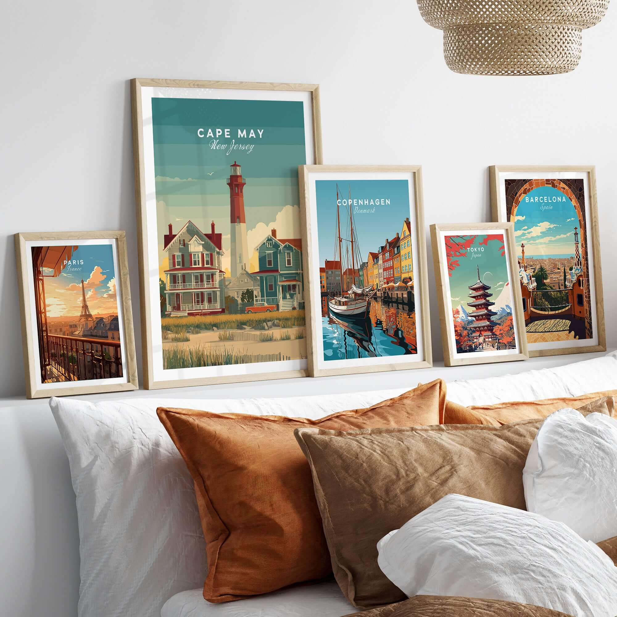 Cape May New Jersey Lighthouse Art Print - Victorian Houses Poster displayed in elegant frames on a shelf.