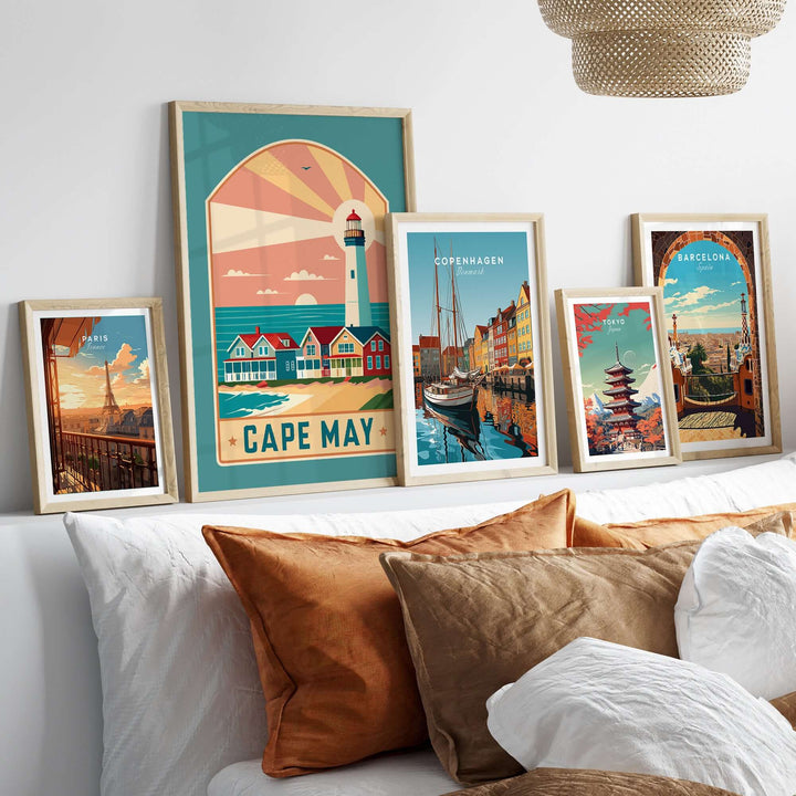 Cape May New Jersey retro travel poster displayed among framed artworks on a cozy bed with decorative pillows.