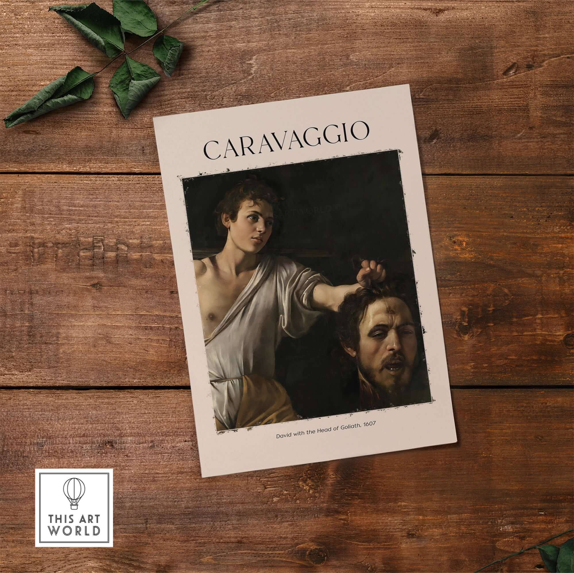 Caravaggio Art Print - David with the Head of Goliath Poster 1607 displayed on wooden table.