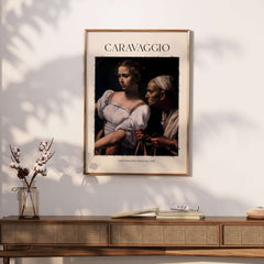 Caravaggio Art Print - Judith Beheading Holofernes Poster 1598 displayed on a wall above a wooden sideboard.