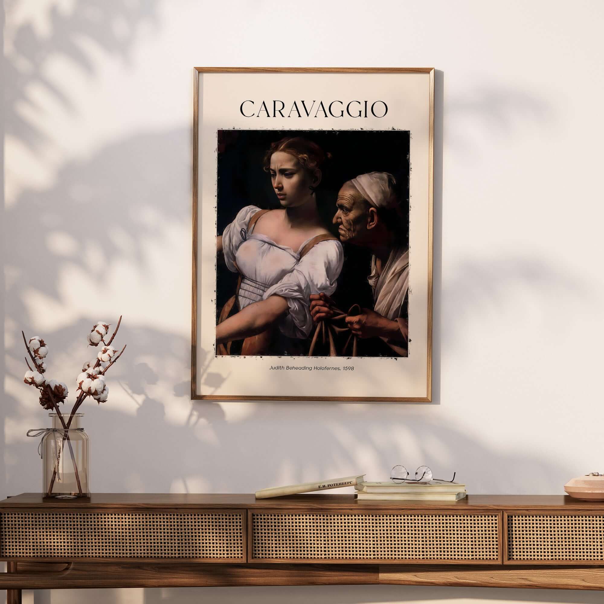 Caravaggio Art Print - Judith Beheading Holofernes Poster 1598 displayed on a wall above a wooden sideboard.