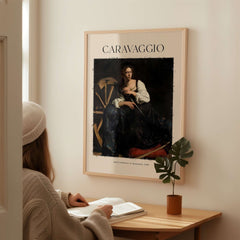 Caravaggio Art Print - Saint Catherine of Alexandria 1598 displayed on wall, woman studying nearby.