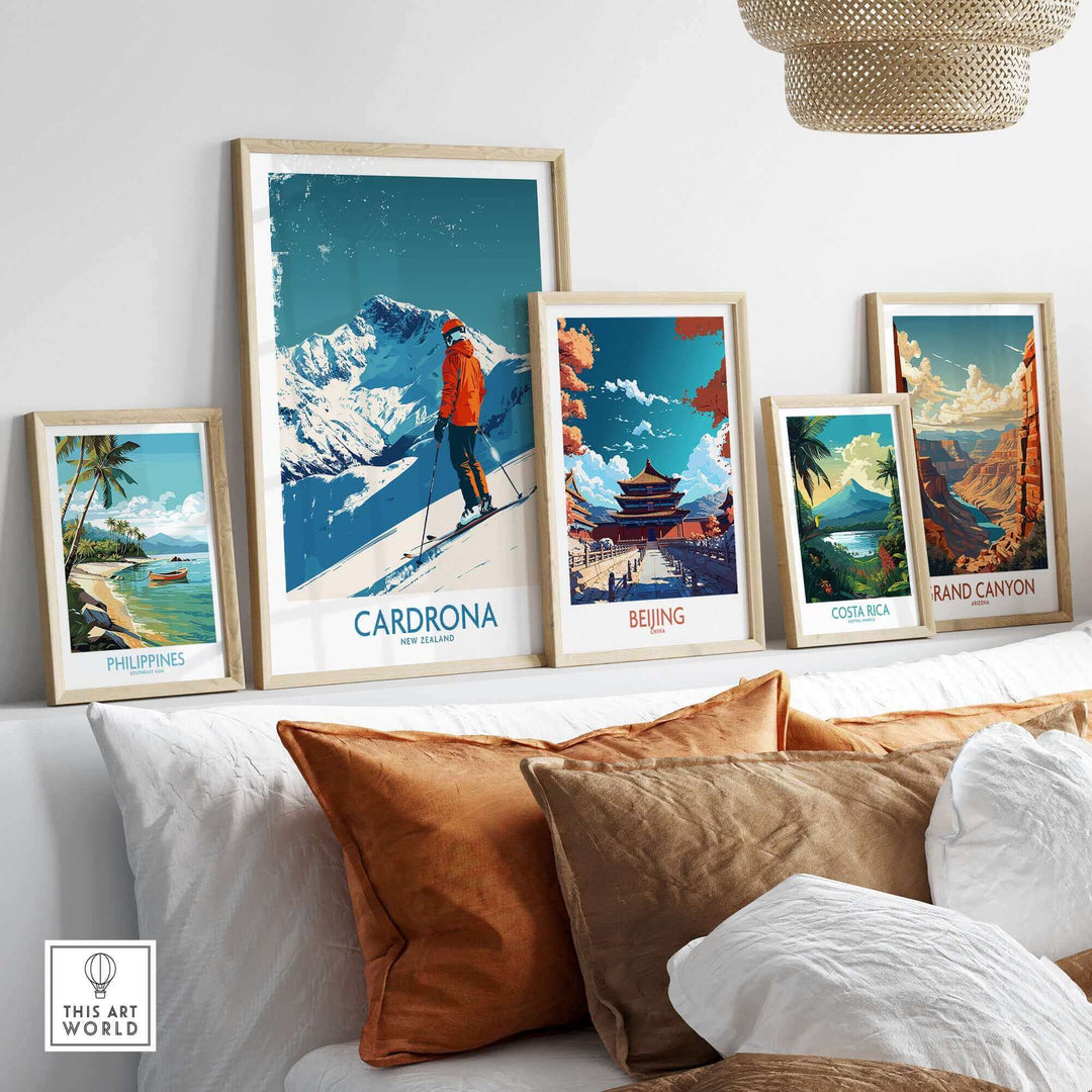 A stylish display of travel-themed prints, including Cardrona Ski Print, on a cozy sofa with decorative pillows.