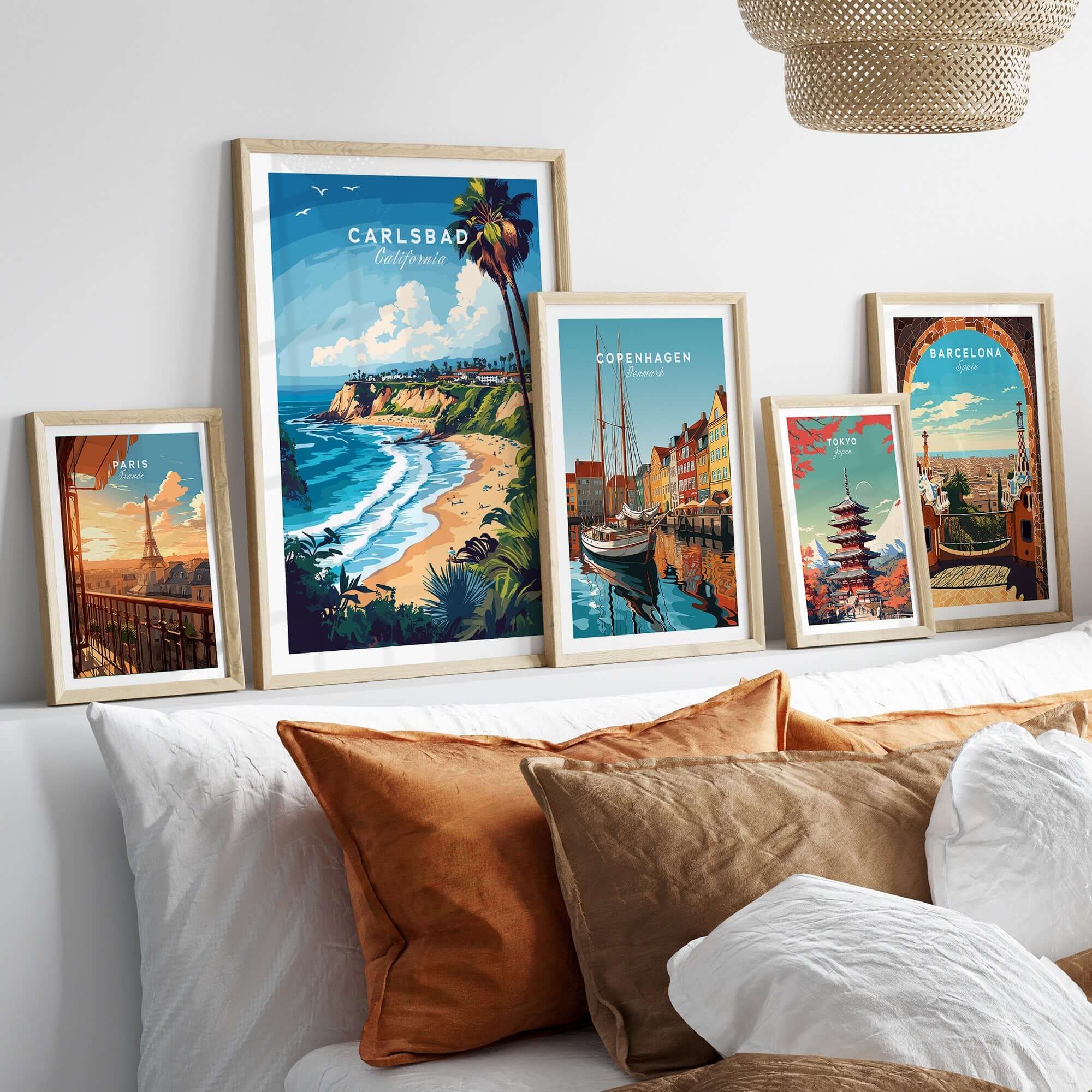 Carlsbad Print California displayed in framed art collection on a stylish bed with decorative pillows.
