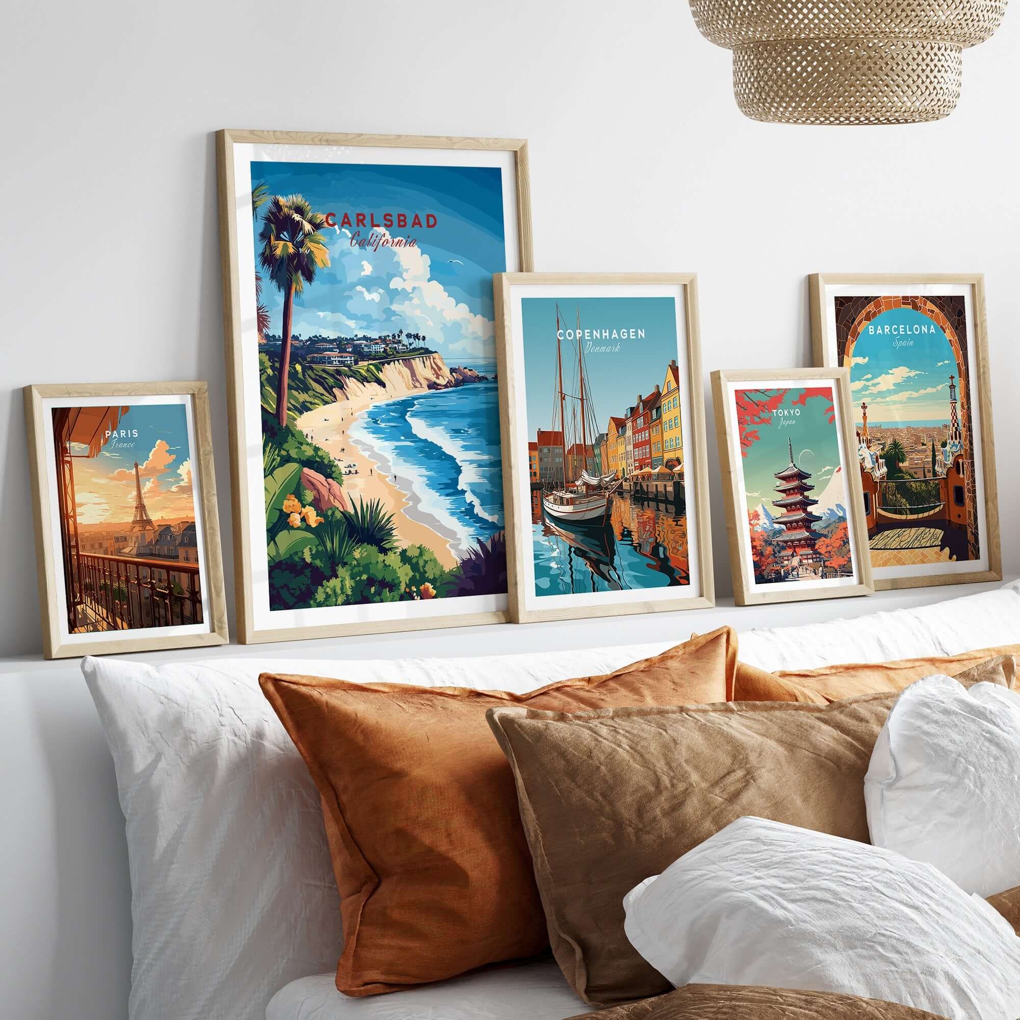 Carlsbad Wall Art showcasing vibrant coastal scenes in stylish frames on a bed with decorative pillows.