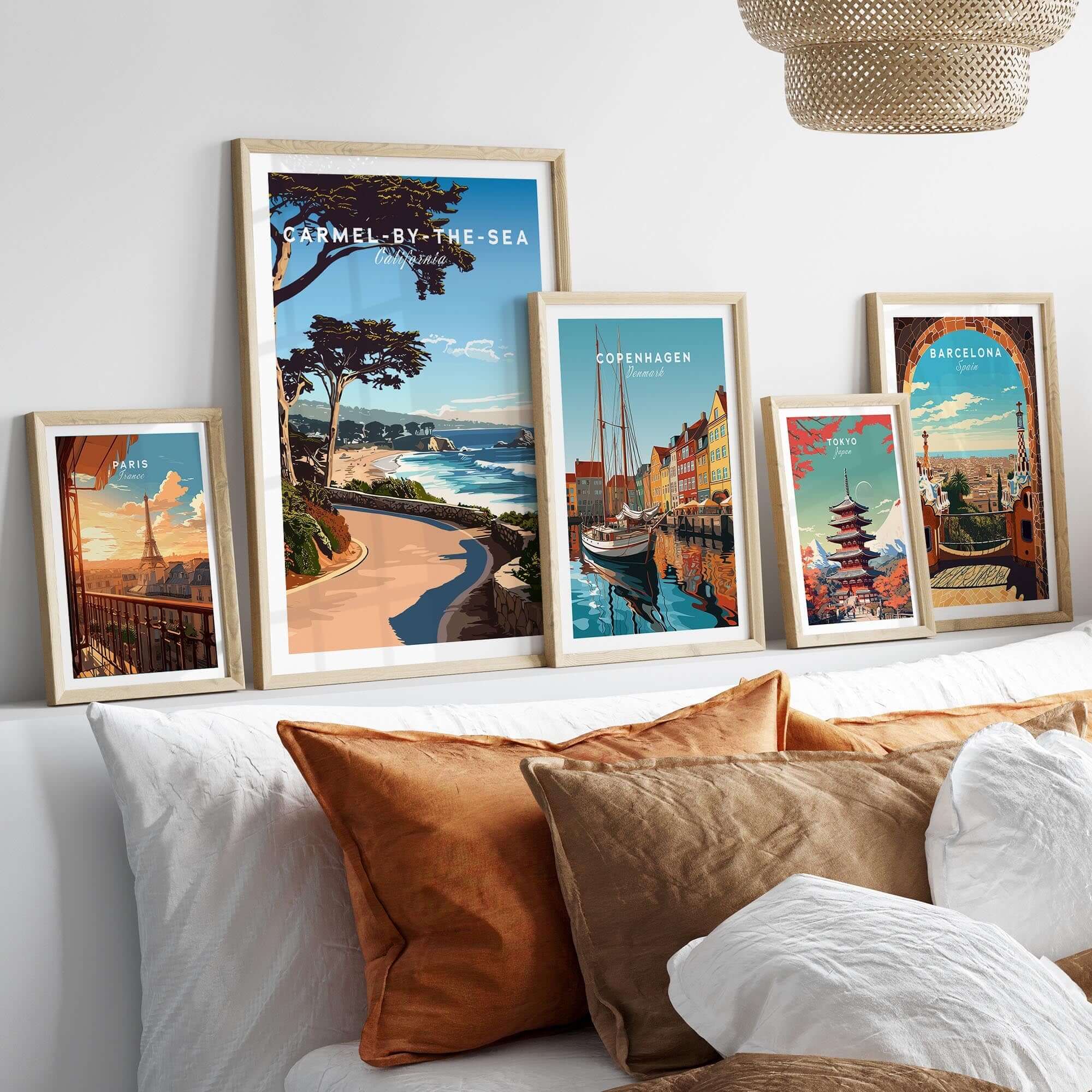 Carmel-by-the-Sea Poster Print displayed among other travel posters in a stylish, cozy home setting.