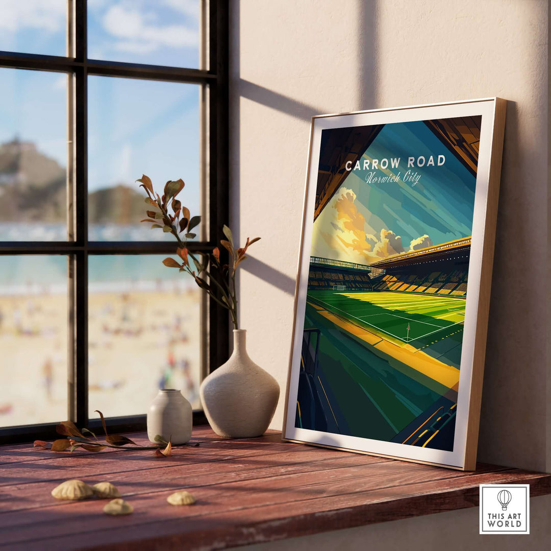 Carrow Road Norwich City stadium wall art print displayed indoors near a window, showcasing vibrant design.