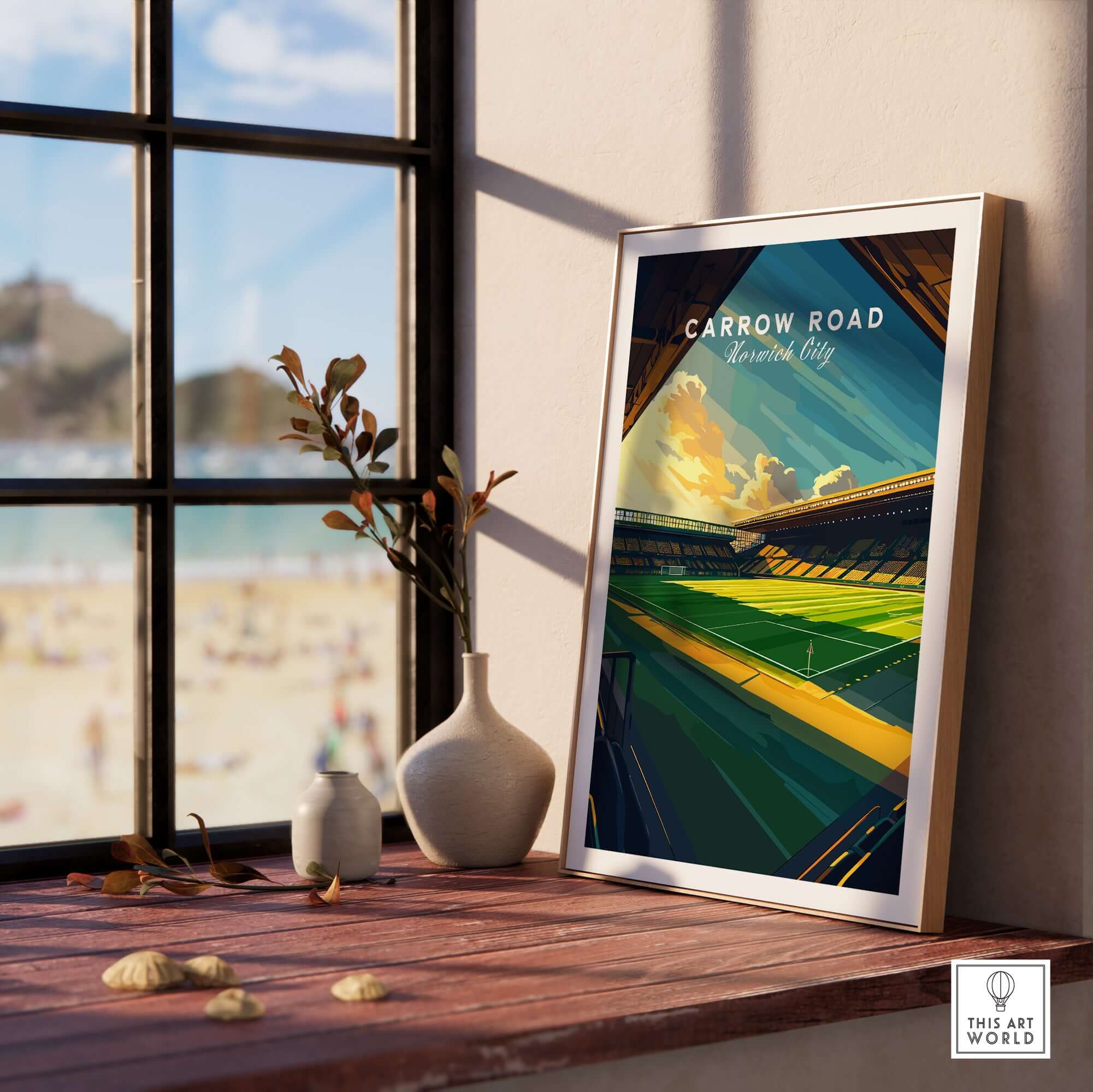 Carrow Road - Norwich City inspired Stadium Wall Art Print displayed on a table with a scenic window view.