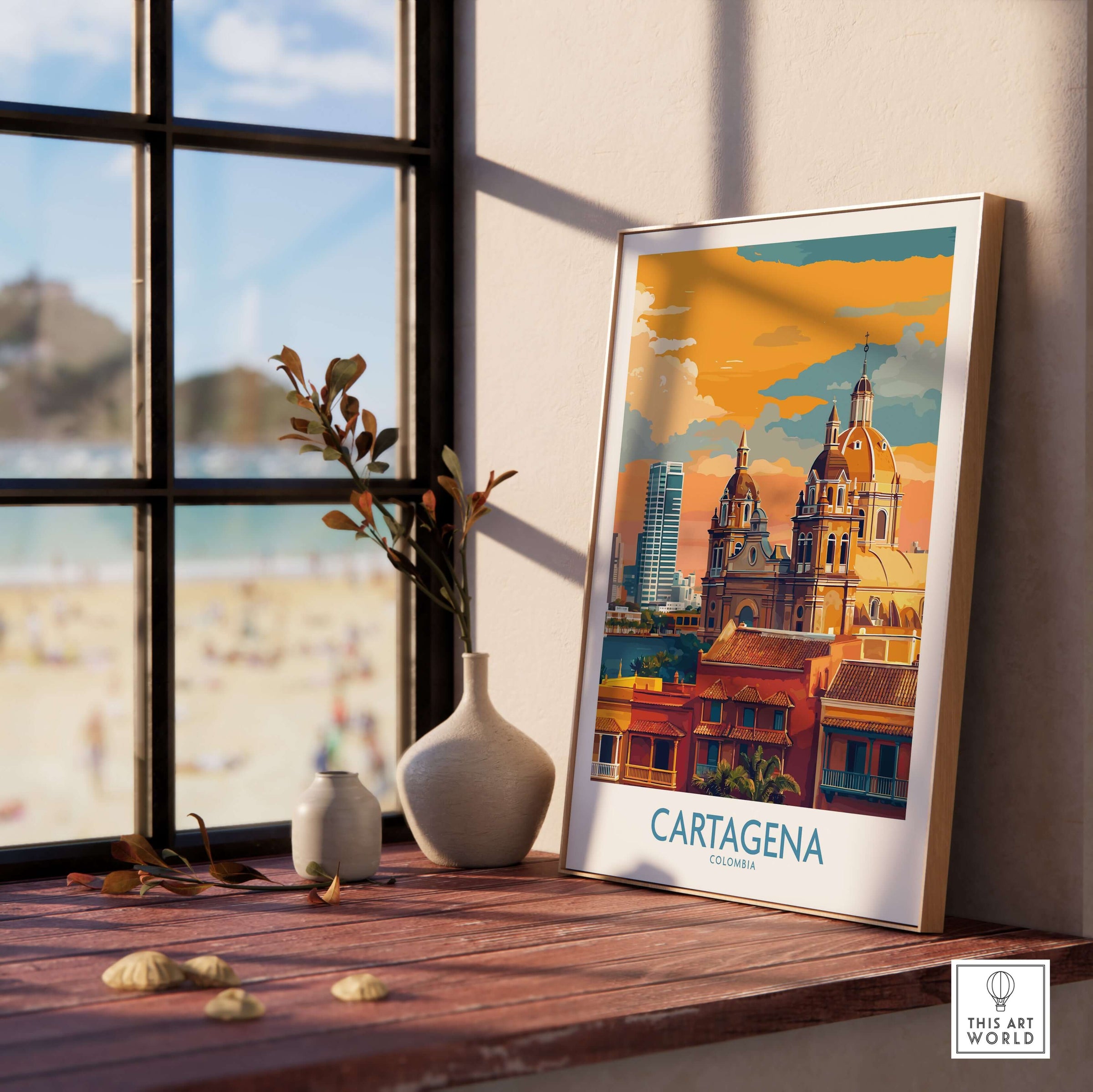 Cartagena Colombia Art Print | Walled City Travel Poster displayed on a wooden table with a beach view.