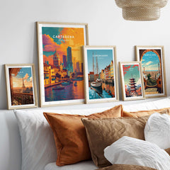 Cartagena Vibrant Tropical City View Print | Caribbean Travel Wall Art displayed among other travel prints on a cozy sofa.