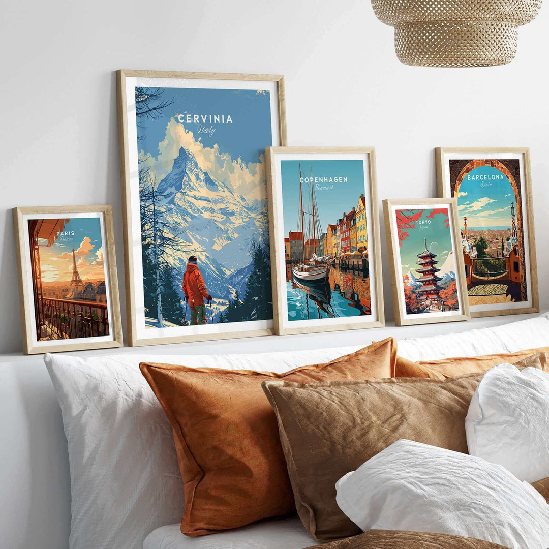 Ski prints featuring Cervinia, Italy, and other cityscapes on a stylish shelf in a cozy living room.